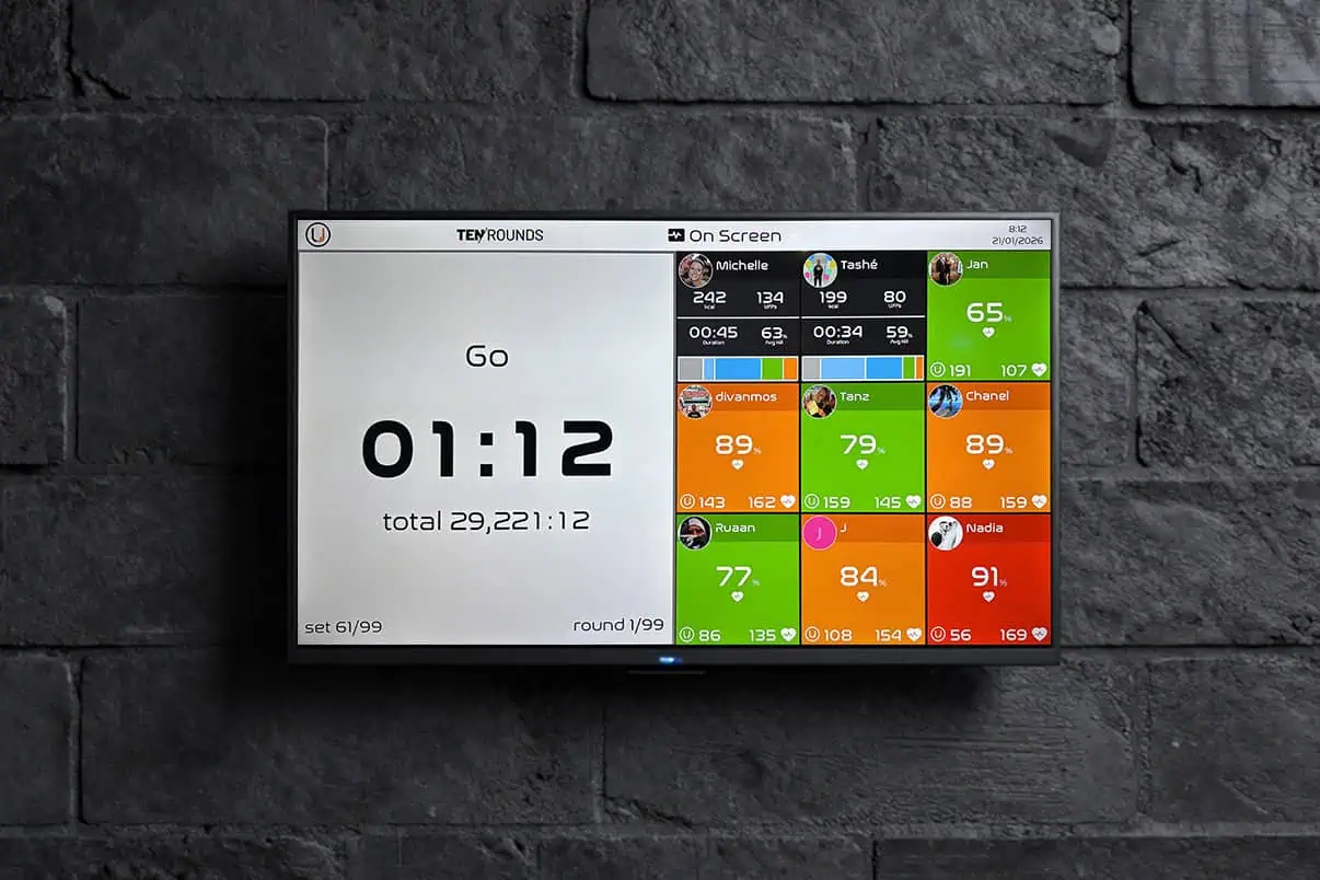TENROUNDS live workout display showing round timer and member heart-rate zones on screen